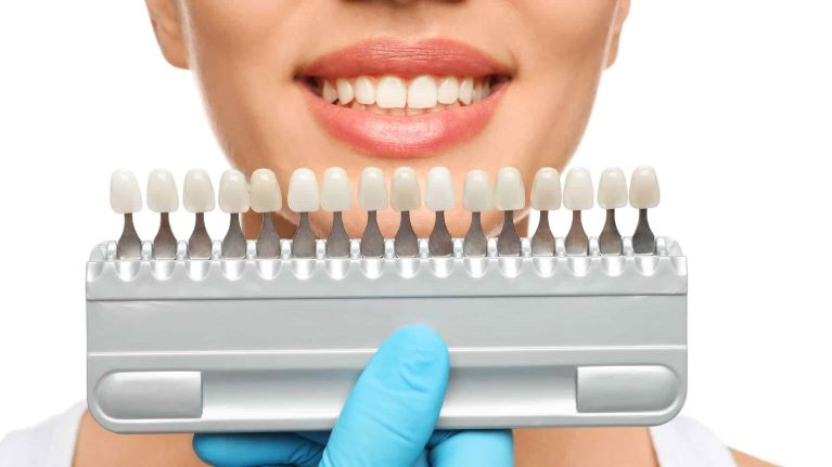 a lady is trying porcelain veneers