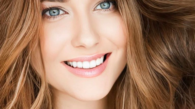 a lady is smiling and showing her teeth