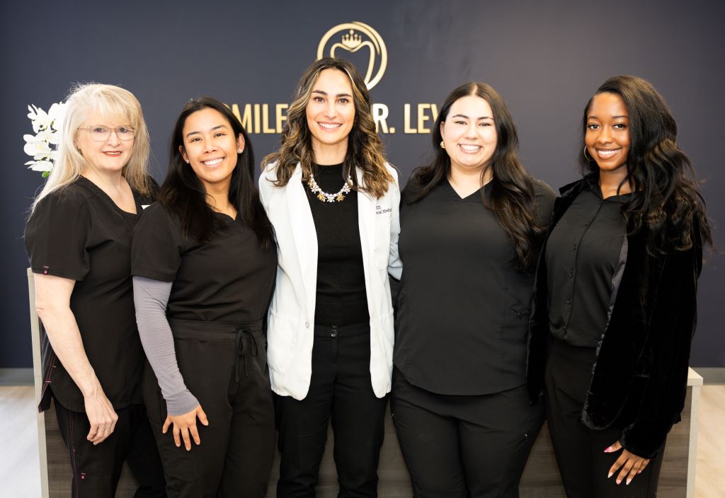 smiles by dr levine dental office's dentists are clicking photo together