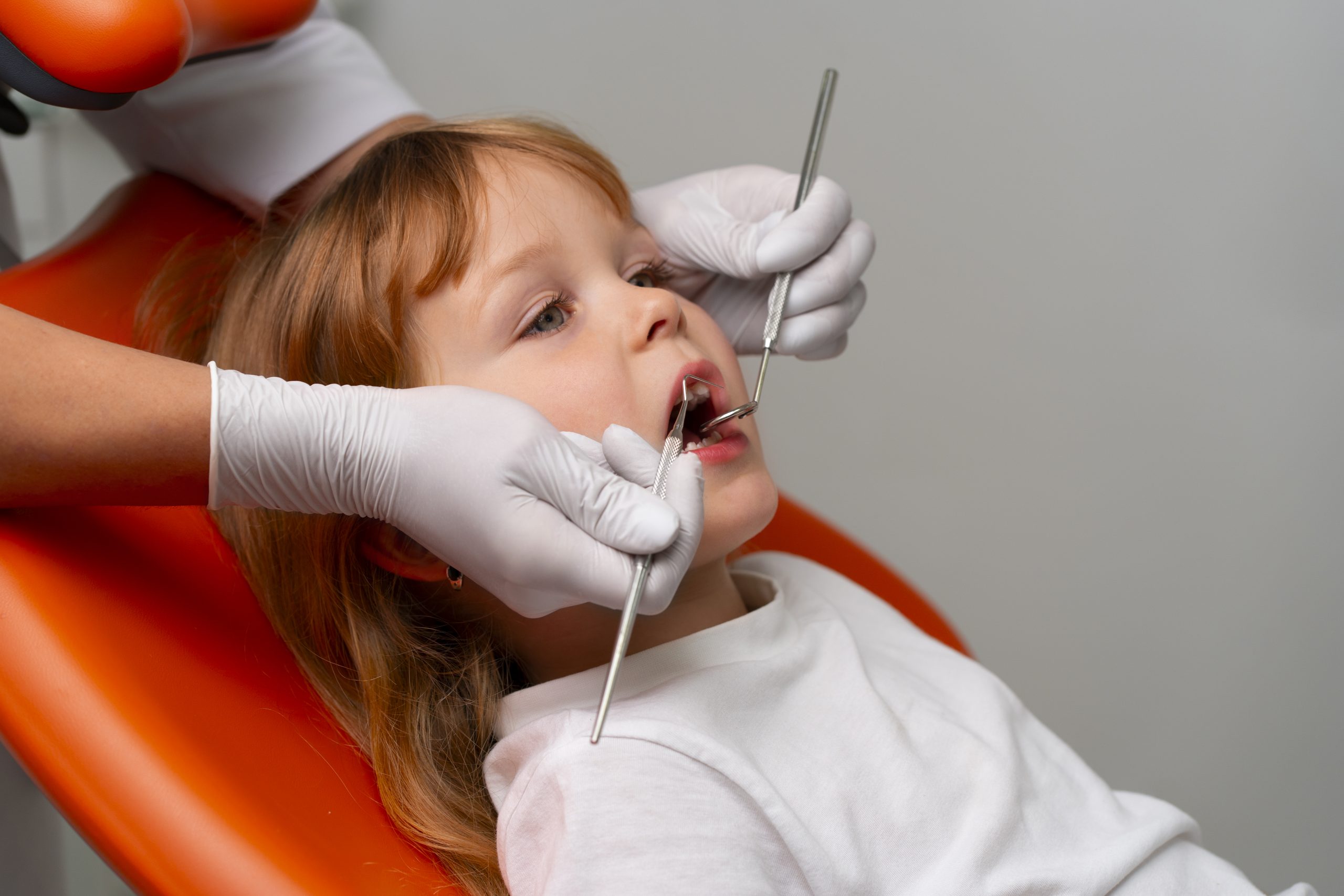 a kid is getting laser dentistry treatment