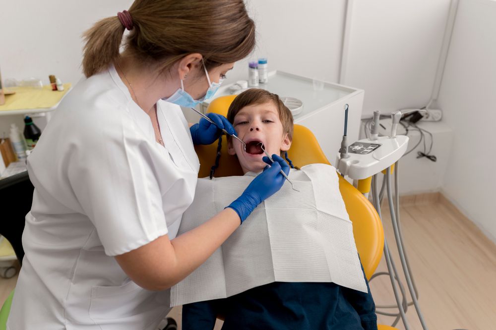 a little boy is getting dental treatment